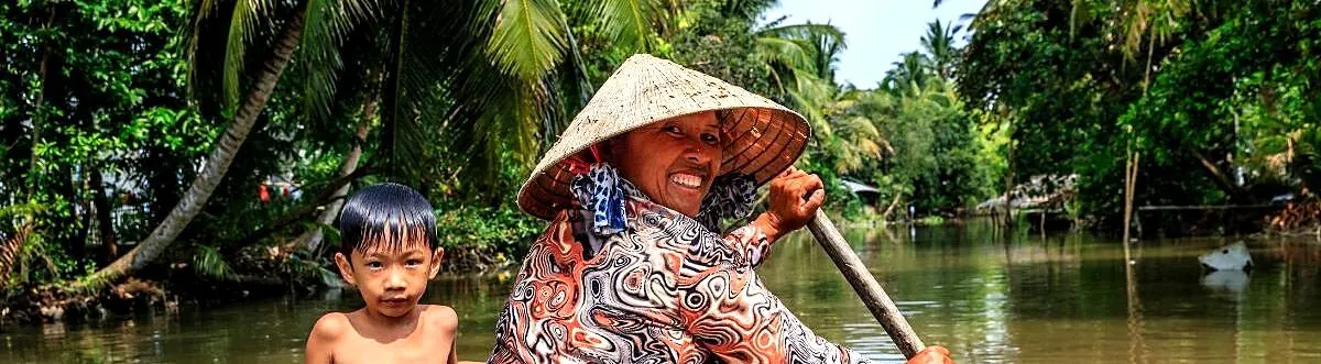 A narrow canal through nipa palms in the Mekong Delta