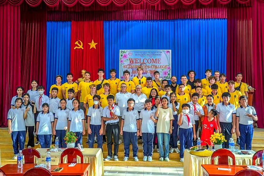 Students and local school partners together on stage in Vietnam