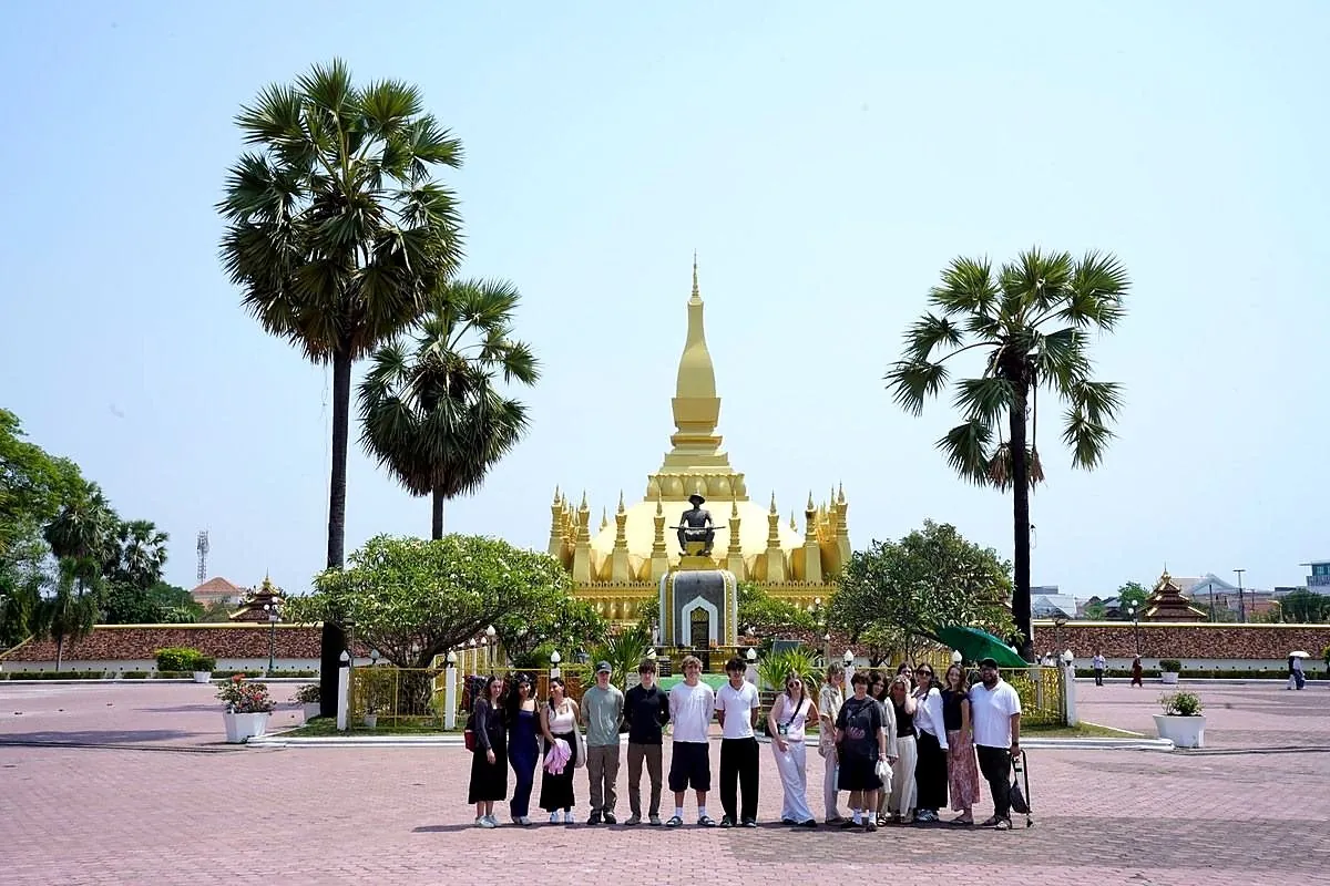 A student group visiting a monument in Vientiane, Laos
