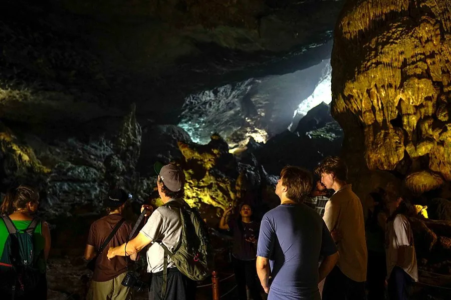 Students visiting a limestone cave in Ha Long Bay