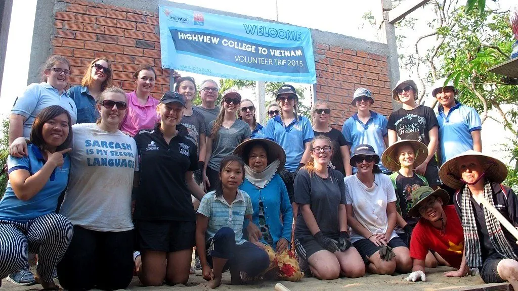 Students and community partners outside a completed house in the Mekong Delta