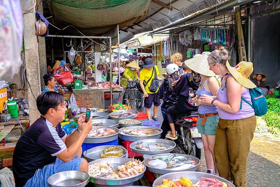 Students examining ingredients at a Vietnamese market