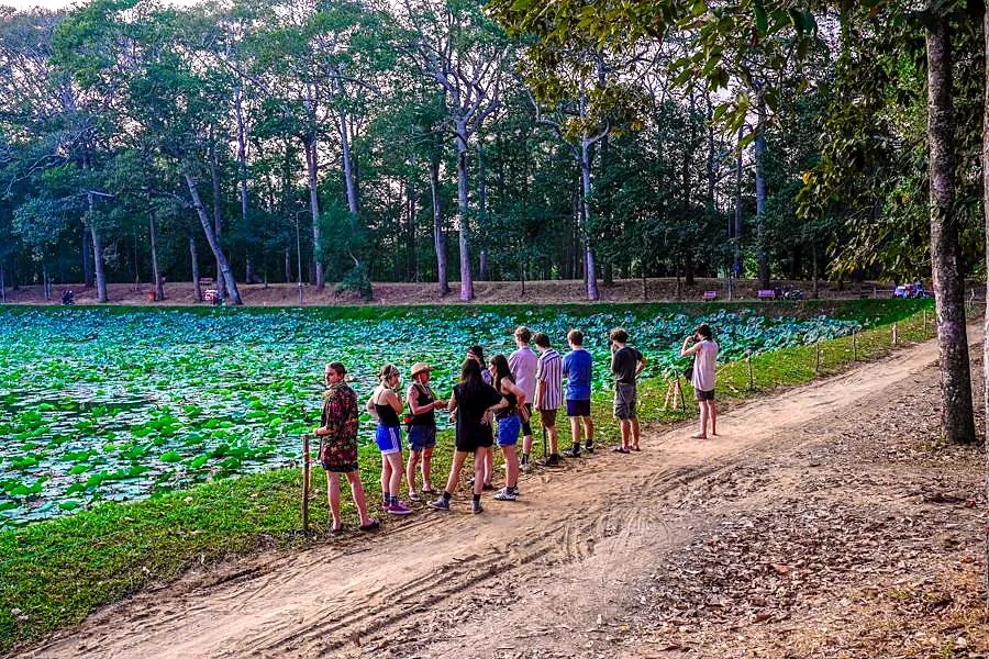 Students walking through a forested field site in Vietnam