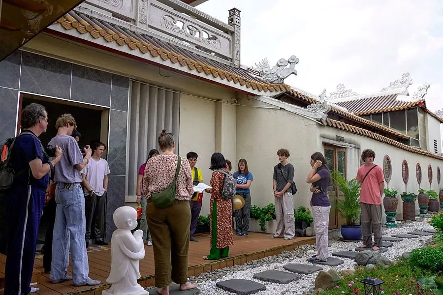 Students visiting a historic house museum in Vietnam