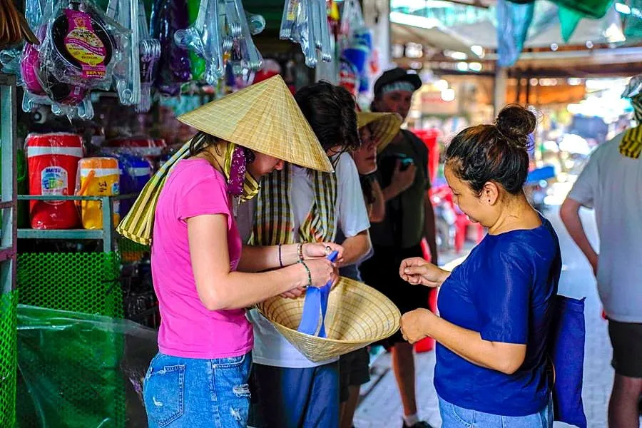 Students speaking with a vendor at a Vietnamese market