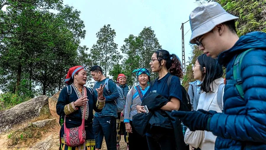 University students taking notes during field research in Sapa