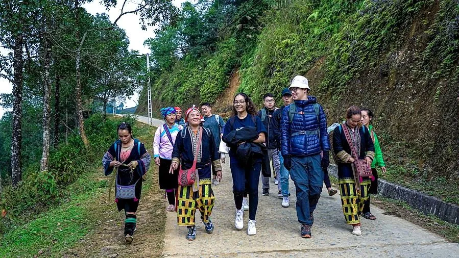 Students walking with local guides in Sapa