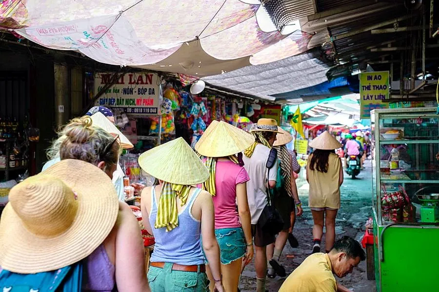 Students walking through a local market in Vietnam